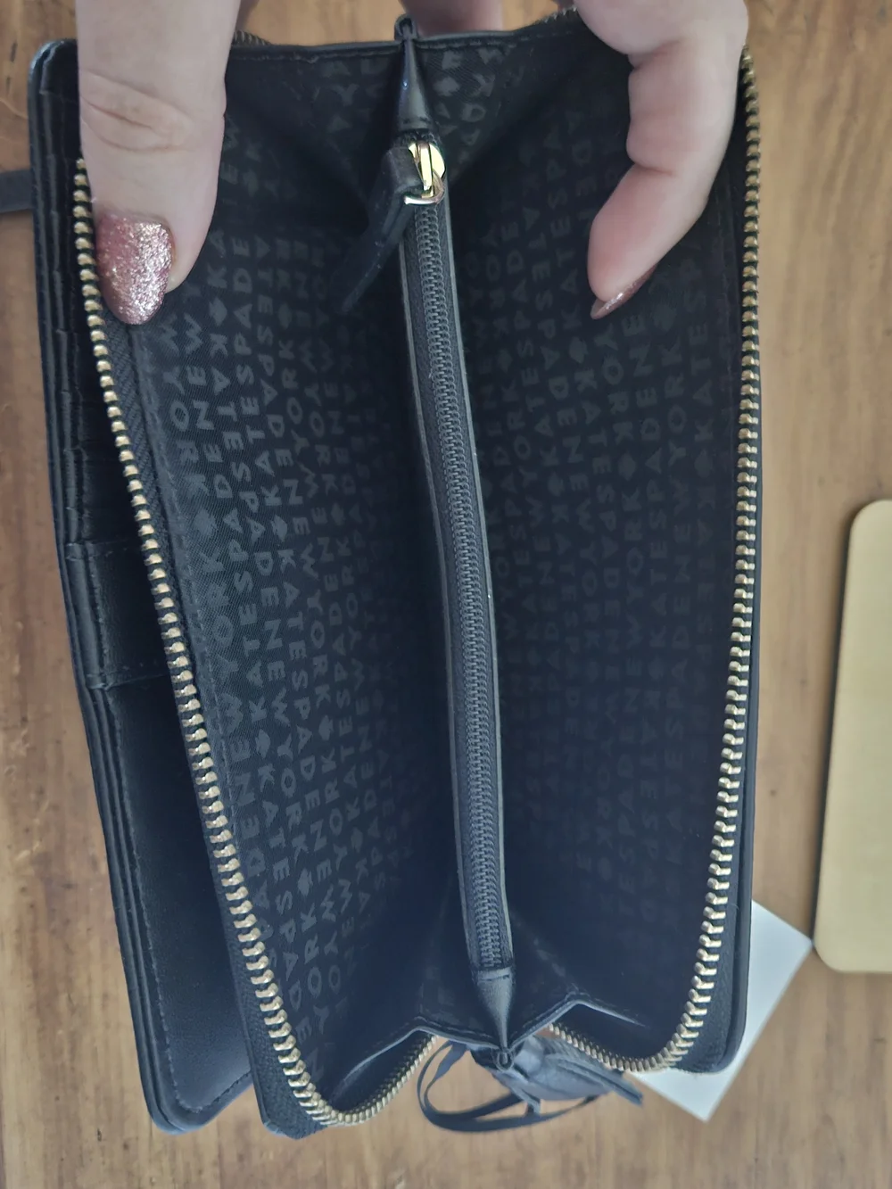 kate spade black pebbled leather wristlet clutch with gold logo